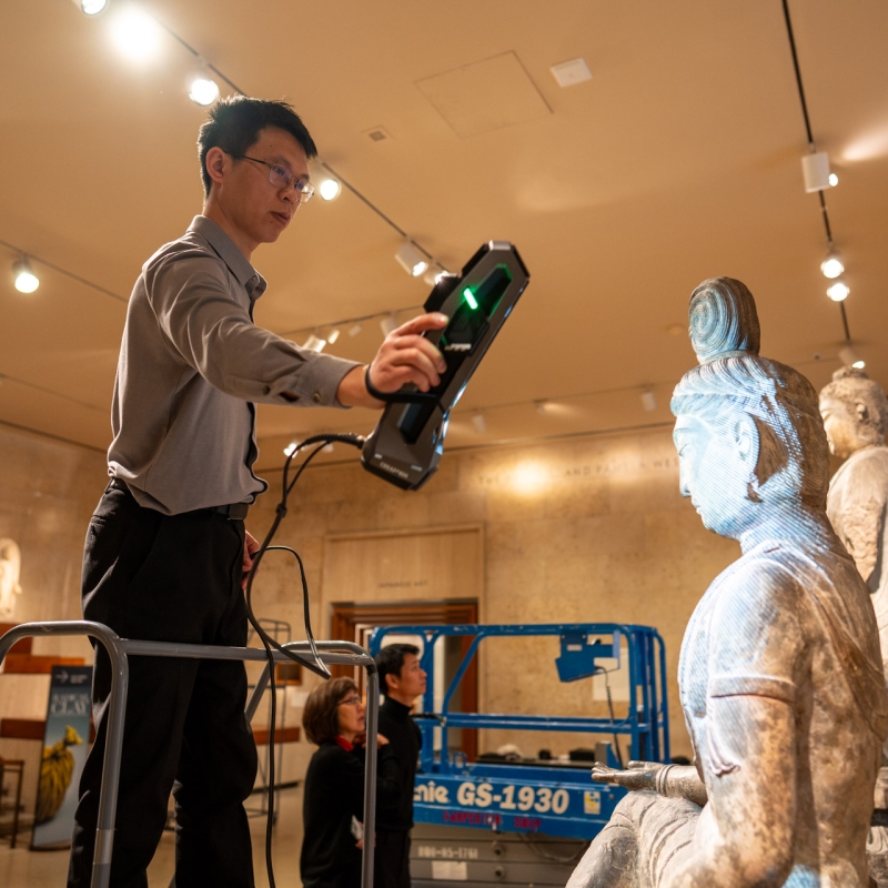 Professor Chen Qiang of Xi'an Jiaotong University conducting 3d scanning of a seated Buddha sculpture, at the Art Institute of Chicago
